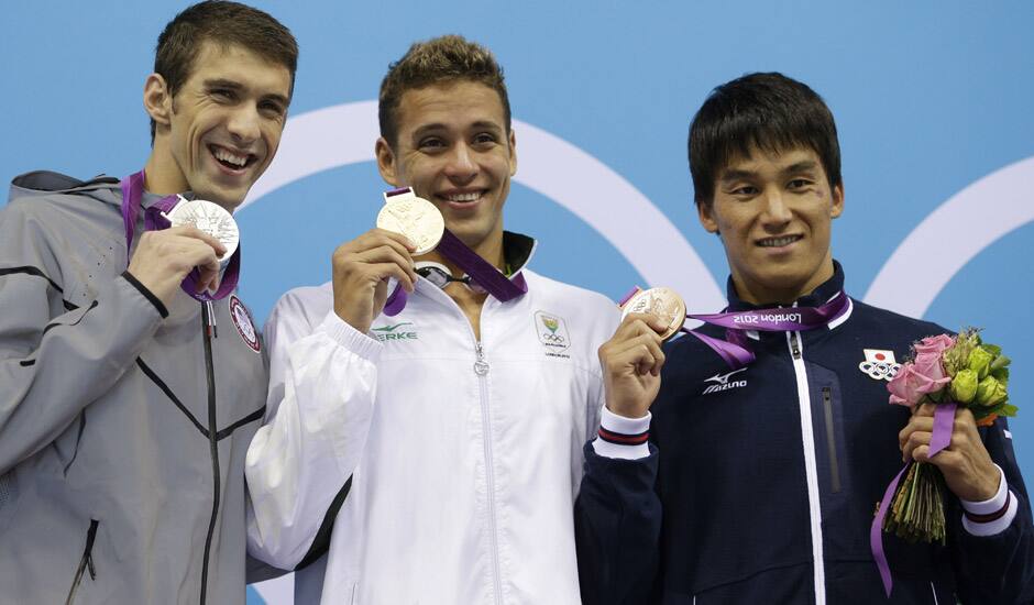 United States' Michael Phelps pose with his medal for the men's 200-meter butterfly swimming final at the Aquatics Centre in the Olympic Park during the 2012 Summer Olympics in London.