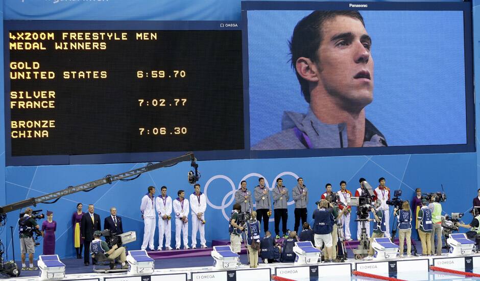 United States' Michael Phelps is seen on a large screen during a medal ceremony for the French, United States and Chinese men's relay teams in the 4 x 200-meter freestyle relay at the Aquatics Centre in the Olympic Park during the 2012 Summer Olympics in London.