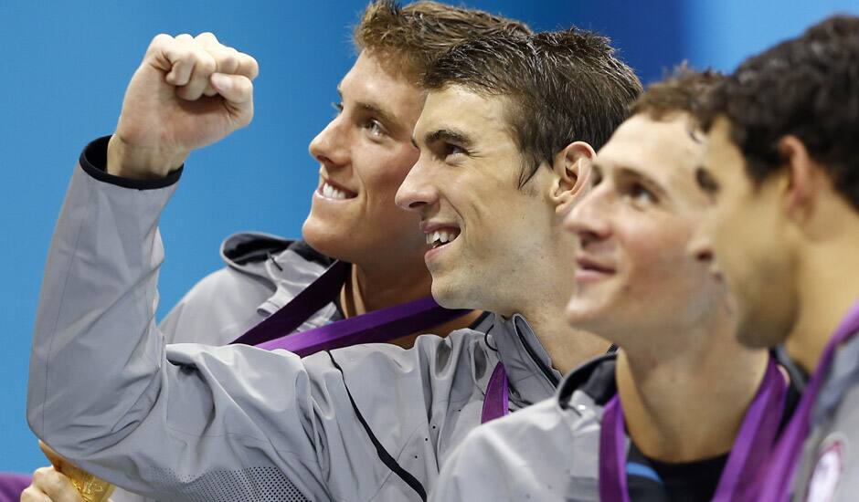 United States' Michael Phelps, center, pose with his gold medal after their win in the men's 4 x 200-meter freestyle relay at the Aquatics Centre in the Olympic Park during the 2012 Summer Olympics in London.