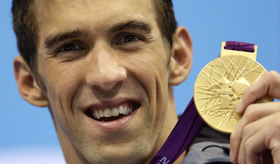 United States' Michael Phelps poses with his medal for the men's 4x200-meter freestyle relay swimming final at the Aquatics Centre in the Olympic Park during the 2012 Summer Olympics in London.