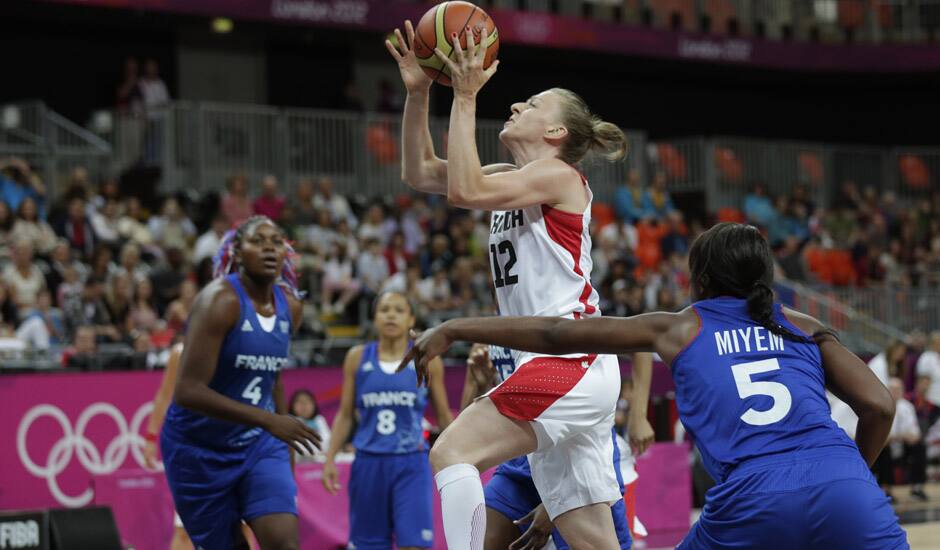 Canada's Lizanne Murphy drives past France's Endene Miyem during a women's basketball game at the 2012 Summer Olympics in London.