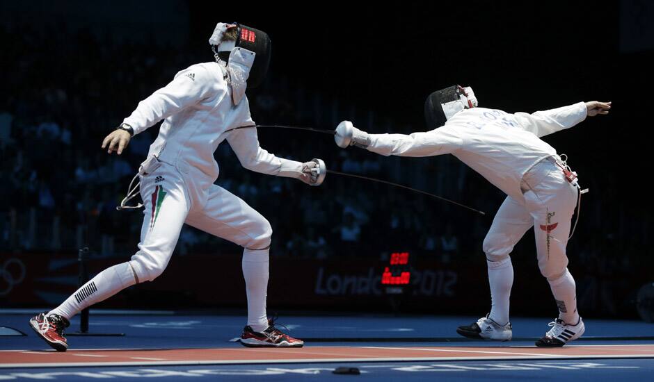 Hungary's Geza Imre, left, competes with Morocco's Abdelkarim El Haouari during men's individual epee fencing at the 2012 Summer Olympics in London. 