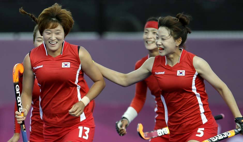 South Korean players celebrate a goal by Cheon Seul-ki (13) during their women's hockey preliminary match against Japan at the 2012 Summer Olympics.