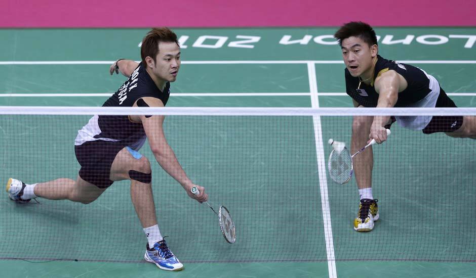 Malaysia's Koo Kien Keat, left, and Tan Boon Heong, play against Thailand's Maneepong Jongjit and Bodin Isara, unseen, at a men's doubles badminton quarterfinal match of the 2012 Summer Olympics.