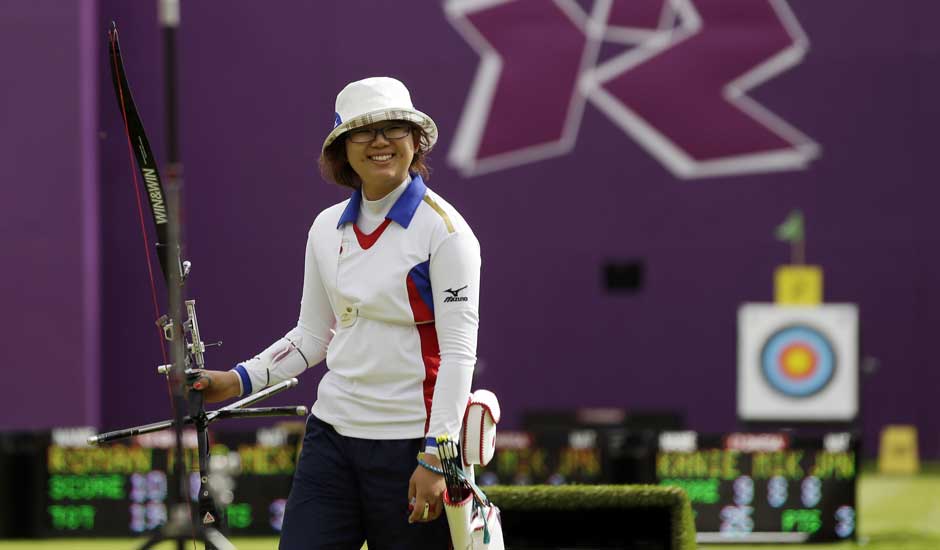 Japan's Miki Kanie smiles after finishing a round during the individual archery competition at the 2012 Summer Olympics.