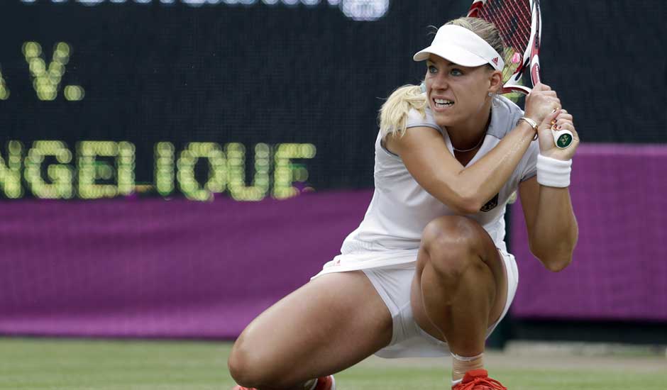 Angelique Kerber of Germany returns to Victoria Azarenka of Belarus at the All England Lawn Tennis Club in Wimbledon, London at the 2012 Summer Olympics.