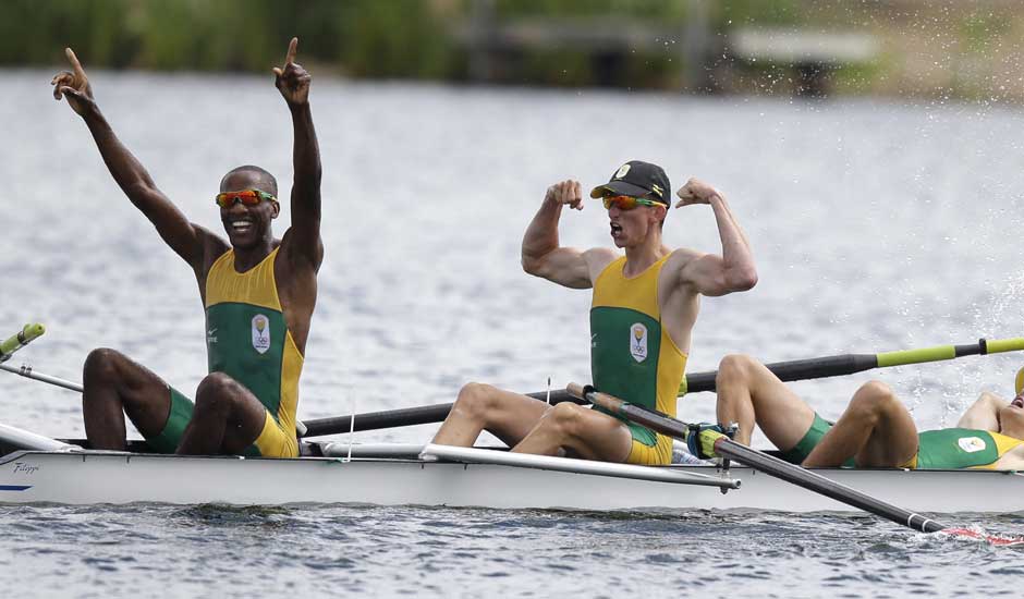 South Africa's, from left, Sizwe Ndlovu, John Smith, Mathew Brittain and James Thompson celebrate after winning the gold medal for the lightweight men's rowing four in Eton Dorney, near Windsor, England, at the 2012 Summer Olympics.