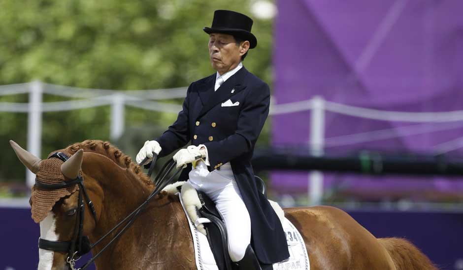 Hiroshi Hoketsu from Japan rides Whisper in the equestrian dressage competition, at the 2012 Summer Olympics.