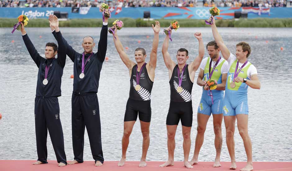 Italy's Romano Battisti and Alessio Sartori , New Zealand's Joseph Sullivan and Nathan Cohen and Slovenia's Iztok Cop and Luka Spik and Iztok Cop celebrate with the medals they won for the men's rowing double sculls in Eton Dorney, near Windsor, England.