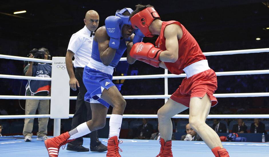 China's Liu Qiang, right, fights Cuba's Yashier Toledo Lopez during their men's light 60-kg boxing match at the 2012 Summer Olympics.