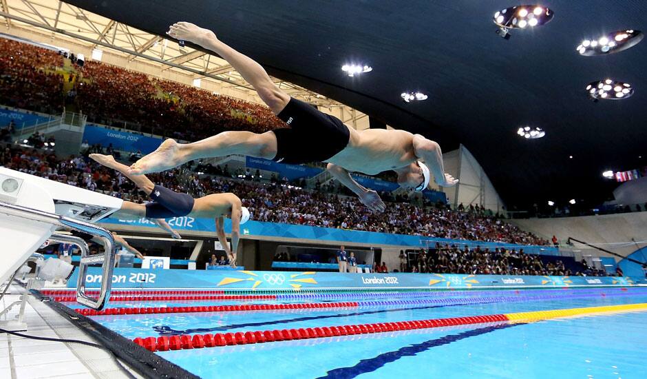 United States' Michael Phelps dives off the starting blocks in the men's 100-meter butterfly swimming race at the 2012 Summer Olympics.