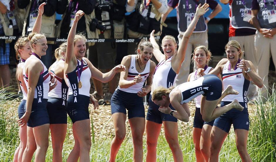 Caryn Davies, Caroline Lind, Eleanor Logan, Meghan Musnicki, Taylor Ritzel, Esther Lofgren, Zsuzsanna Francia, and Erin Cafaro throw coxswain Mary Whipple into the water after winning the gold medal for the women's rowing eight in Eton Dorney, near Windsor, England.