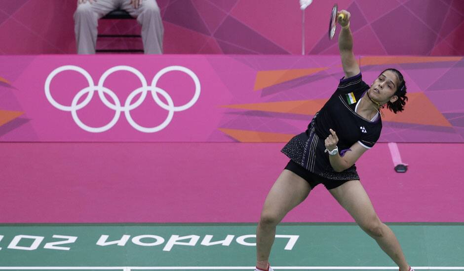 Saina Nehwal plays against Denmark's Tine Baun, unseen, at a women's singles badminton quarterfinal match of the 2012 Summer Olympics.