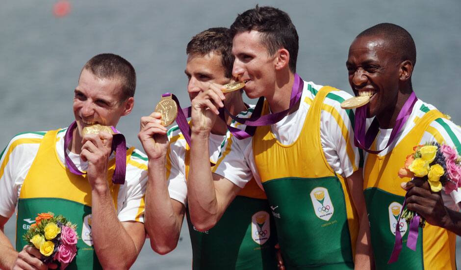 South Africa's Sizwe Ndlovu, John Smith, Mathew Brittain and James Thompson kiss the gold medals they won for the lightweight men's rowing four in Eton Dorney, near Windsor, England, at the 2012 Summer Olympics.