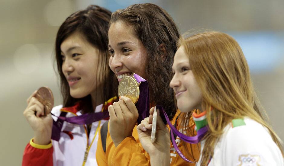 China's Tang Yi, Netherlands' Ranomi Kromowidjojo and Belarus' Aliaksandra Herasimenia pose with their medals for the women's 100-meter freestyle swimming final at the Aquatics Centre in the Olympic Park during the 2012 Summer Olympics in London.