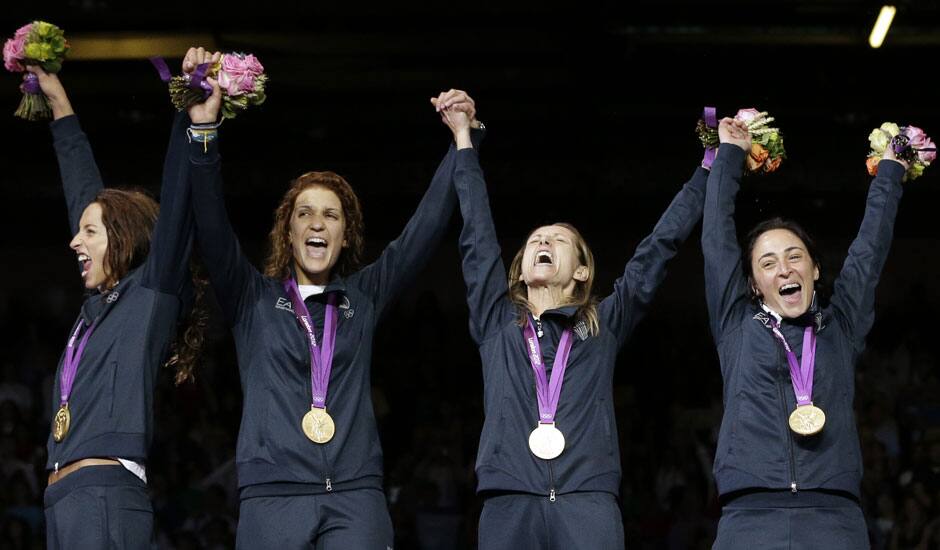 Italy's gold medalists Elisa Di Francisca, left to right, Arianna Errigo, Valentina Vezzali and Ilaria Salvatori celebrate after defeating Russia in the gold medal match at women's team foil fencing at the 2012 Summer Olympics.