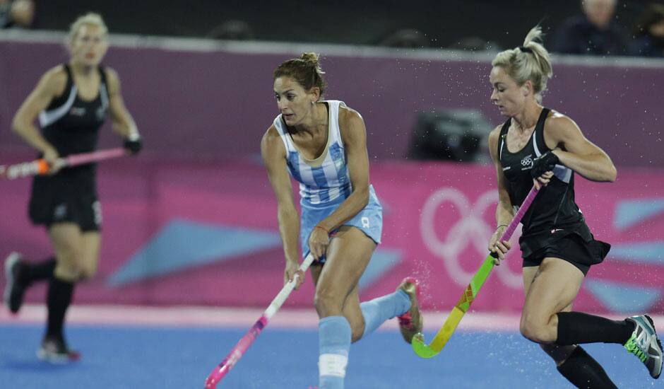 Argentina's captain Luciana Aymar runs with the ball during a women's hockey preliminary round match against New Zealand, at the 2012 Summer Olympics.