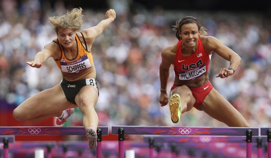 Netherlands' Dafne Schippers, and United States' Chantae McMillan clear a hurdle in the 100-meter hurdles of the Women's Heptathlon during the athletics in the Olympic Stadium at the 2012 Summer Olympics, London.