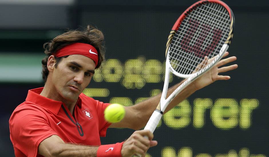 Roger Federer of Switzerland returns to Juan Martin del Potro of Argentina at the All England Lawn Tennis Club in Wimbledon, London at the 2012 Summer Olympics.