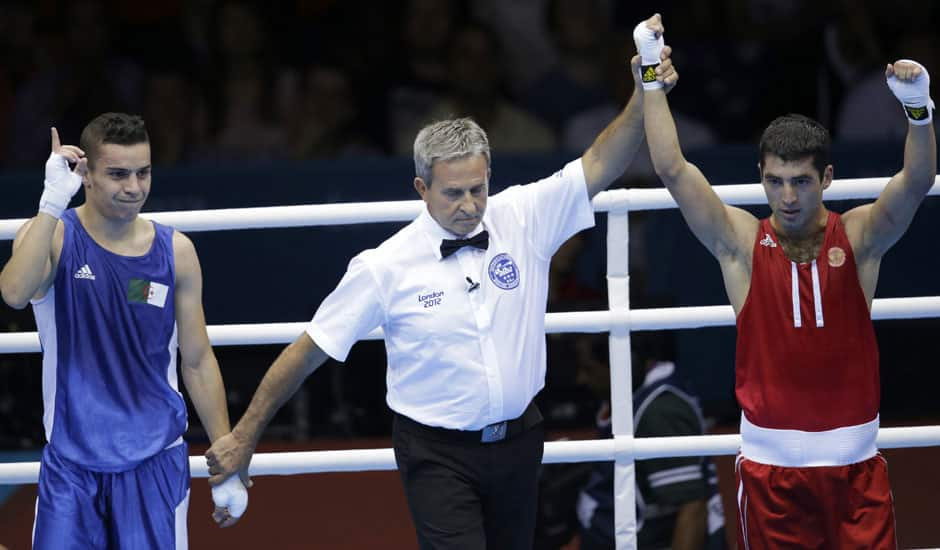 Russia's Misha Aloian, right, reacts after defeating Algeria's Samir Brahimi during a men's flyweight 52-kg preliminary boxing match at the 2012 Summer Olympics.