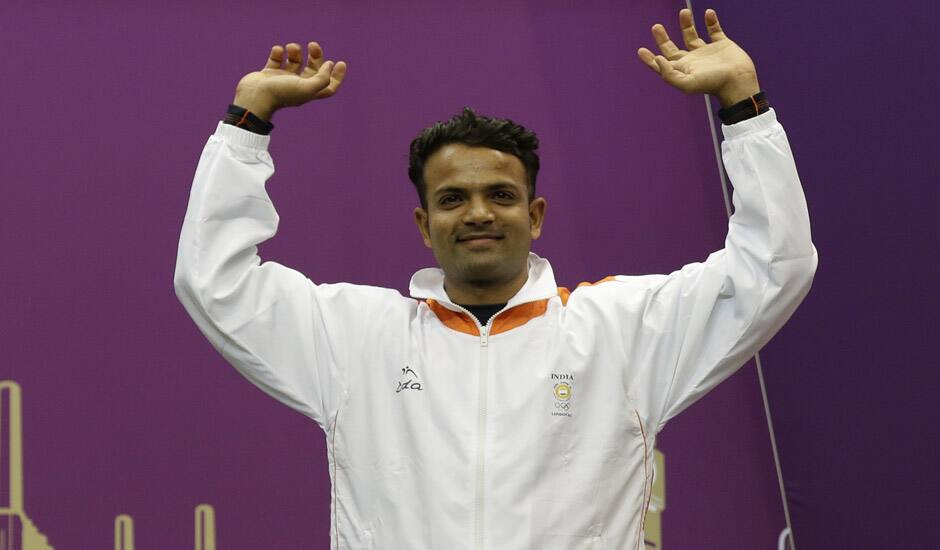 Vijay Kumar reacts as he mounts the medals podium to receive a silver for the men's 25-meter rapid fire pistol event at the 2012 Summer Olympics in London.