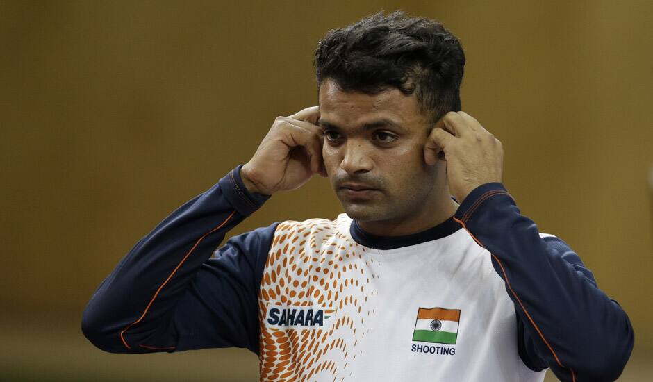 dia's Vijay Kumar removes his ear plugs at the end of the men's 25-meter rapid fire pistol final at the 2012 Summer Olympics, Friday, Aug. 3, 2012, in London. Kumar finished second to win the silver.