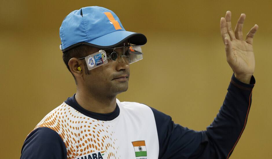 India's Vijay Kumar waves as he is introduced at the start of the men's 25-meter rapid fire pistol final at the 2012 Summer Olympics, Friday, Aug. 3, 2012, in London. Kumar finished second to win the silver.