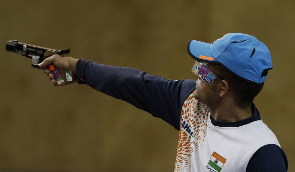 India's Vijay Kumar shoots during the men's 25-meter rapid fire pistol final at the 2012 Summer Olympics, Friday, Aug. 3, 2012, in London. Kumar finished second to win the silver.