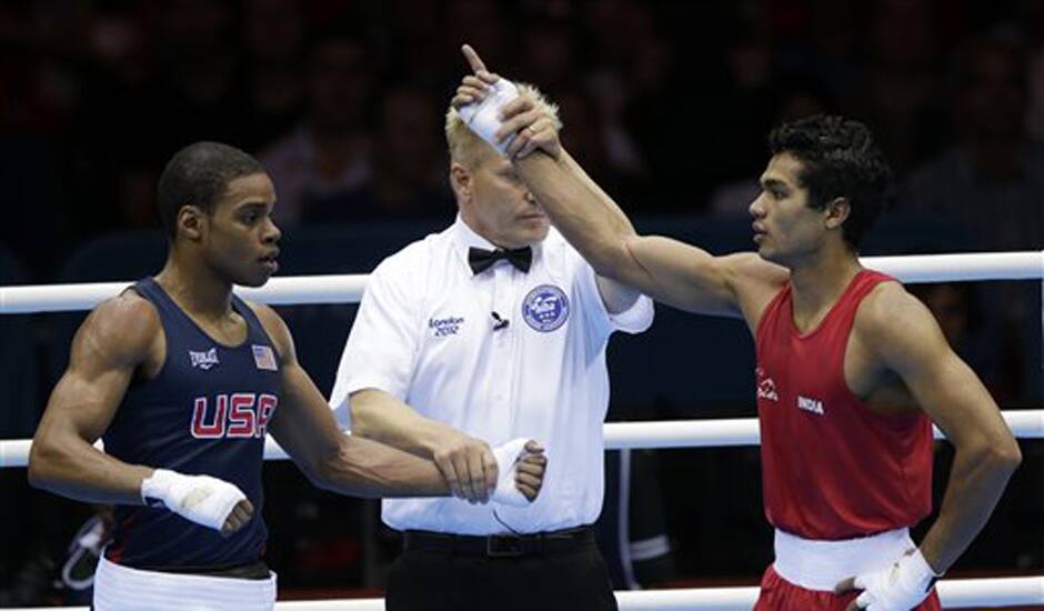 India's Krishan Vikas, right, reacts after defeating the United States' Errol Spence during a men's welterweight 69-kg preliminary boxing match at the 2012 Summer Olympics