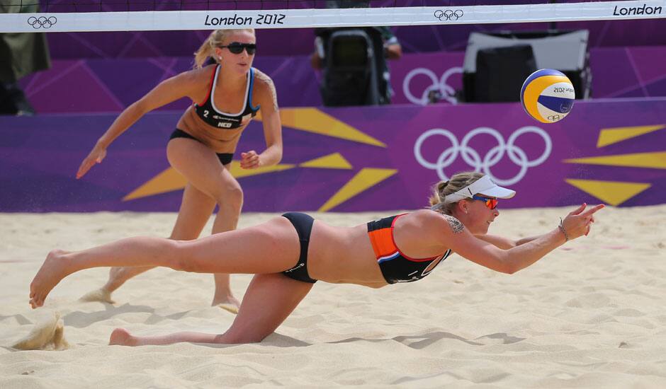 Sophie Van Gestel,  from Netherlands looks on as her teammate Madelein Meppelink dives for a ball during the Beach Volleyball match against Brazil at the 2012 Summer Olympics in London.