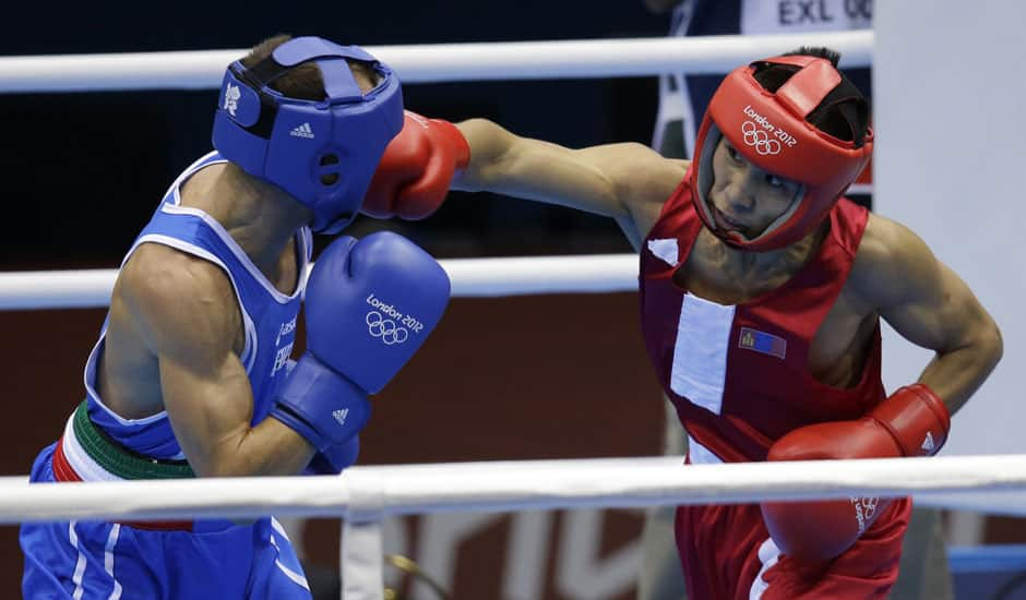 Mongolia's Tugstosgt Nyambayar, punches Italy's Vincenzo Picardi during a men's flyweight 52-kg preliminary boxing match at the 2012 Summer Olympics in London. 