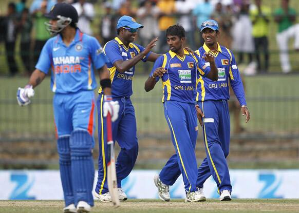 Sri Lanka's bowler Nuwan Pradeep, celebrates the dismissal of Virat Kohli, with Sachithra Senanayake, right and Angelo Mathews during their fifth one day international cricket match in Pallekele.