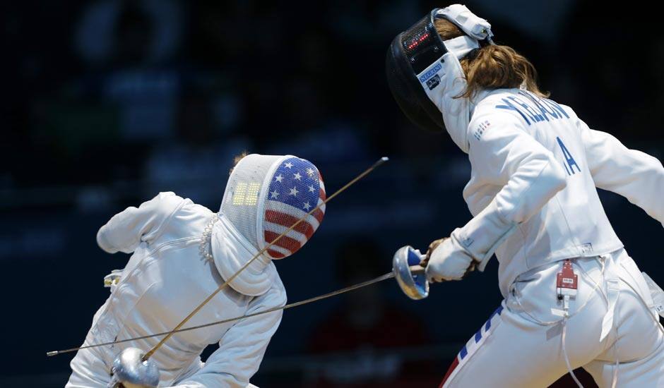 United States' Susie Scanlan, left, competes against Italy's Nathalie Moellhausen during women's team epee fencing at the 2012 Summer Olympics.