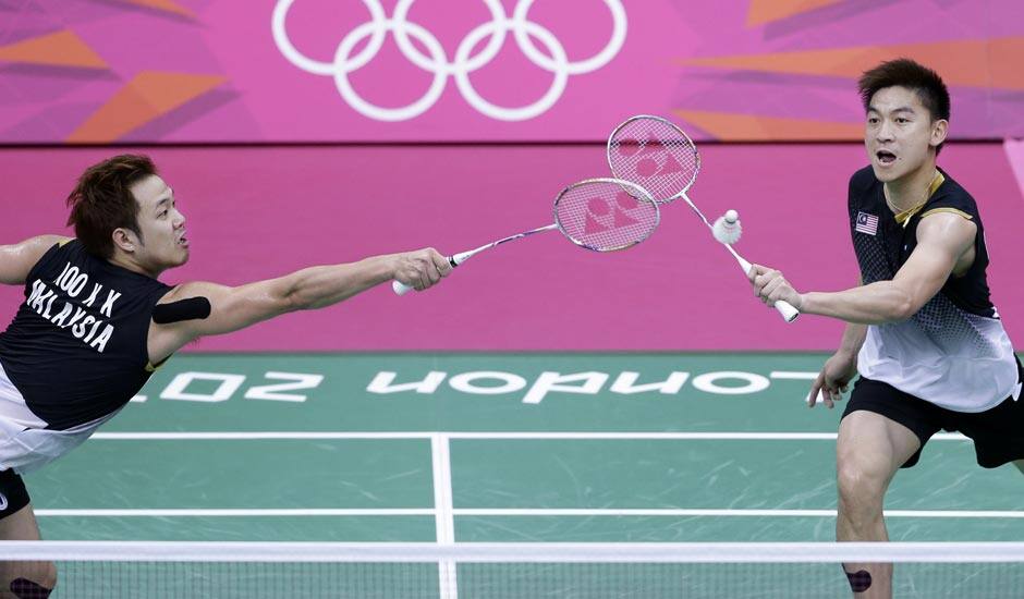 Malaysia's Koo Kien Keat, left, and Tan Boon Heong, play against China's Cai Yun and Fu Haifeng, unseen, at a men's doubles badminton semifinal match of the 2012 Summer Olympics.