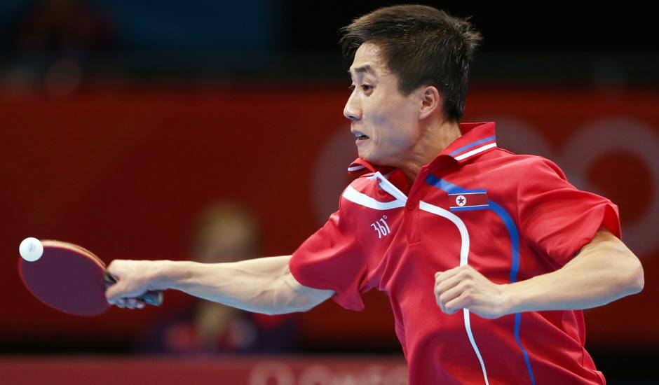 Kim Hyok Bong of North Korea competes against Ryu Seungmin of South Korea during men's team table tennis competition at the 2012 Summer Olympics.