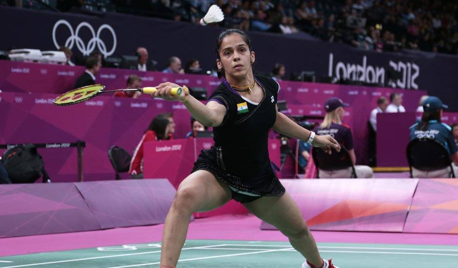 Saina Nehwal plays against Belgium's Lianne Tan, unseen, at a woman's singles badminton match of the 2012 Summer Olympics.