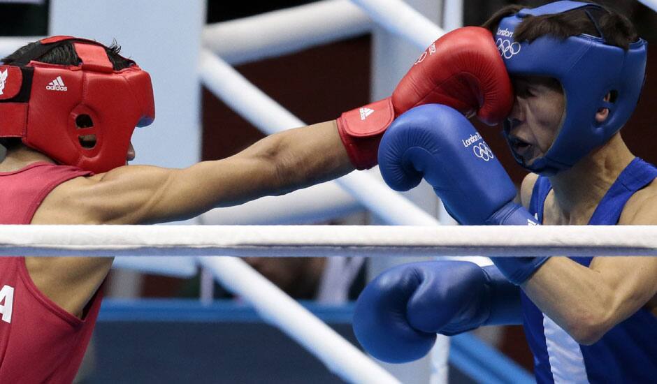 India's Devendro Singh Laishram, left, and Mongolia's Serdamba Pureverdorj, fight during the men's light flyweight boxing competition at the 2012 Summer Olympics.