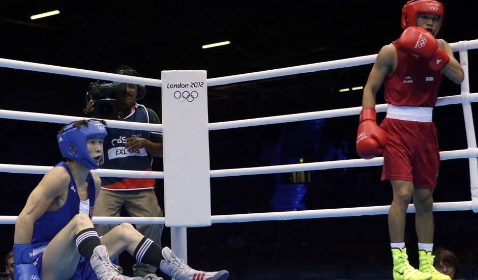 Devendro Singh Laishram of India, right, knocks down Serdamba Purevdorj of Mongolia, during their fight at the men's light flyweight boxing at the 2012 Summer Olympics.