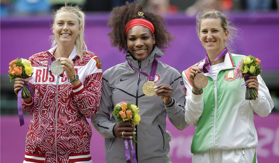 From left, silver medalist Maria Sharapova of Russia, gold medalist Serena Williams of the United States and bronze medalist Victoria Azarenka of Belarus stand on the podium during the medal ceremony of the women's singles final match at the All England Lawn Tennis Club at Wimbledon