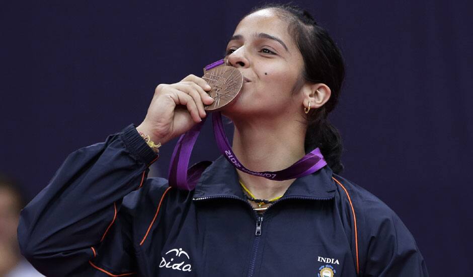 India's Saina Nehwal kisses his bronze medal of the badminton women's singles at the 2012 Summer Olympics, Saturday, Aug. 4, 2012, in London.