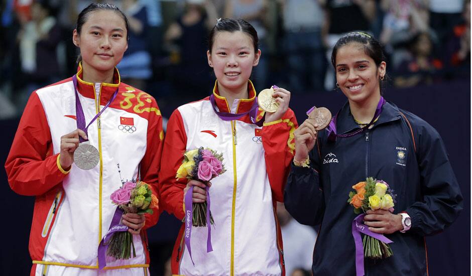 Gold medalist Li Xuerui, center, silver medalist Wang Yihan, left, both from China, and bronze medalist Saina Nehwal of India, pose at the podium of the badminton women's singles at the 2012 Summer Olympics.