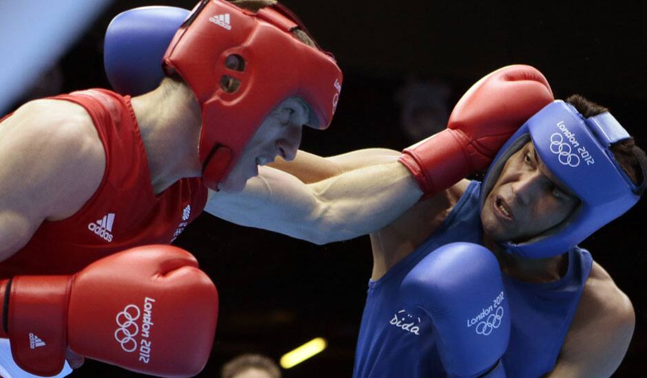 Thomas Stalker of Great Britain, left, and Manoj Kumar of India, fight during the men's light welterweight boxing competition at the 2012 Summer Olympics