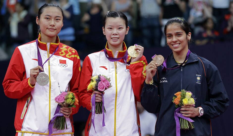 Gold medalist Li Xuerui, center, silver medalist Wang Yihan, left, both from China, and bronze medalist Saina Nehwal of India, pose at the podium of the badminton women's singles at the 2012 Summer Olympics.