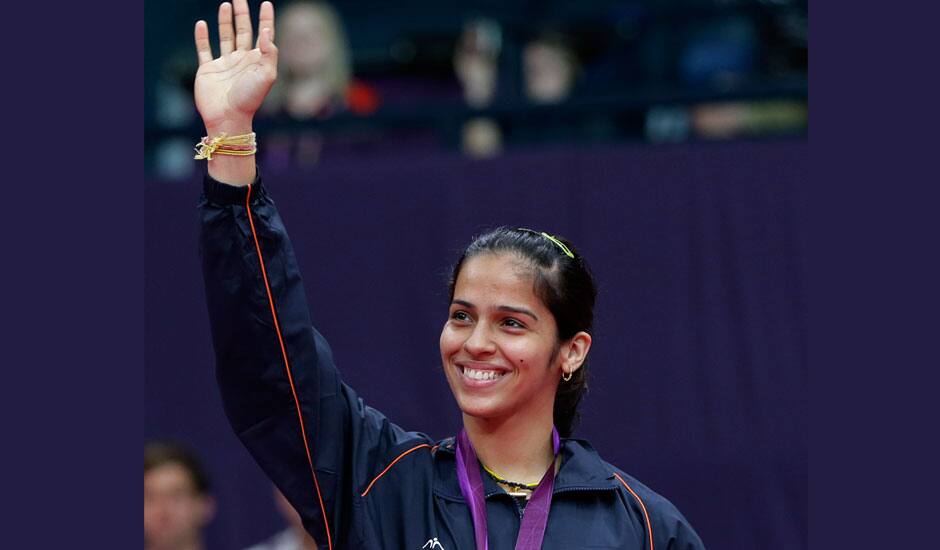 Bronze medalist Saina Nehwal, of India, waves to the crowd from the podium of the badminton women's singles at the 2012 Summer Olympics.