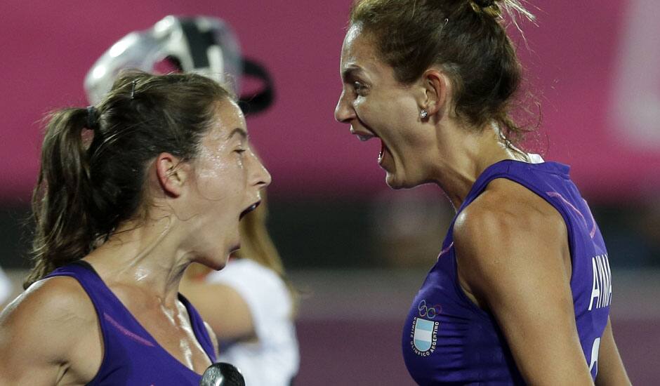 Argentina's Luciana Aymar, right, celebrates her goal during a women's hockey preliminary match against Germany at the 2012 Summer Olympics.