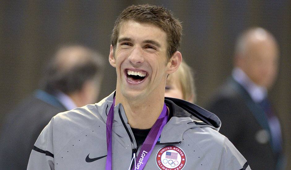 United States' swimmer Michael Phelps smiles as he wears his gold medal at the Aquatics Centre in the Olympic Park during the 2012 Summer Olympics.