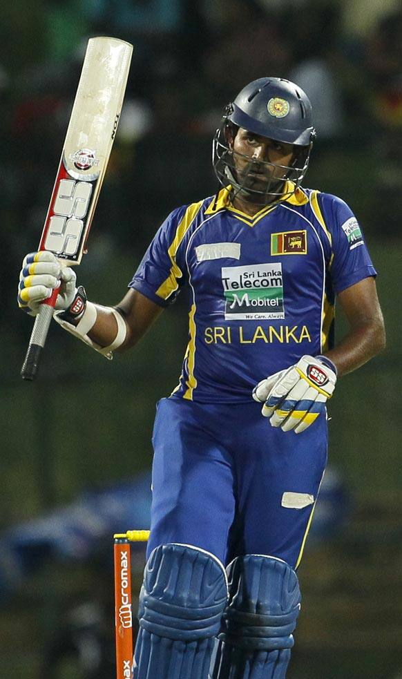 Sri Lanka's batsman Lahiru Thirimanne celebrates after scoring a half century during the fifth one day international cricket match between India and Sri Lanka in Pallekele, Sri Lanka.