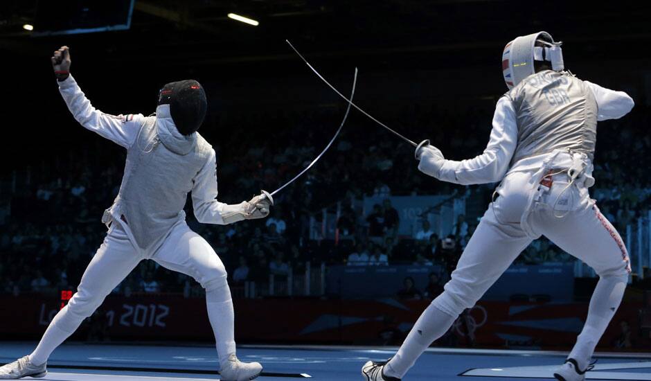 Alaaeldin Abouelkassemn of Egypt competes against James-Andrew Davis of Great Britain, right, during the men's foil team fencing competition at the 2012 Summer Olympics.