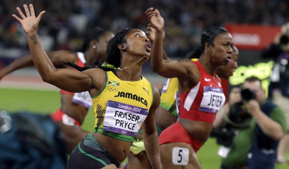 Gold medal winner, Jamaica's Shelly-Ann Fraser-Pryce, left, crosses the finish line ahead of silver medal winner United States' Carmelita Jeter during the women's 100-meter final during athletics competition in the Olympic Stadium at the 2012 Summer Olympics.