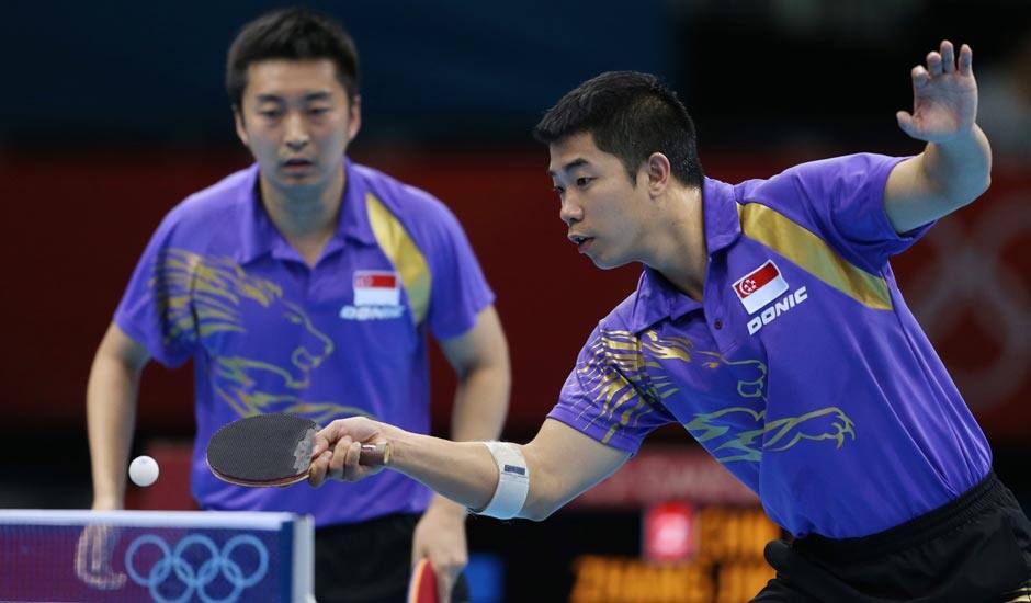 Singapore's Jian Zhan, right, and Zi Yang compete against a team from China in the men's team quarterfinals table tennis match at the 2012 Summer Olympics.